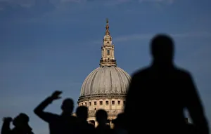 People are silhouetted as the walk past a view of St Pauls Cathedral in London, Britain People are silhouetted as the walk past a view of St Pauls Cathedral in London, Britain