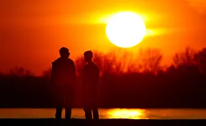 People stand on the bank of Volga river during the sunset in Samara People stand on the bank of Volga river during the sunset in Samara