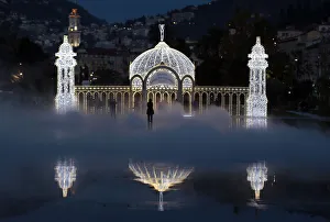 People stand in the mist as they look at a replica of the casino along the Promenade People stand in the mist as they look at a replica of the casino along the Promenade