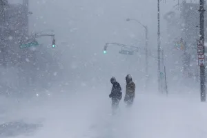 People struggle against wind and snow during Storm Grayson at the Jersey shore in Long People struggle against wind and snow during Storm Grayson at the Jersey shore in Long