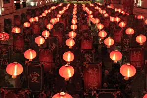 People walk under a Chinese Lantern display during a Chinese New Year eve celebration People walk under a Chinese Lantern display during a Chinese New Year eve celebration