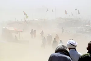 People walk through a dust storm on the banks of the Ganga river in Allahabad People walk through a dust storm on the banks of the Ganga river in Allahabad
