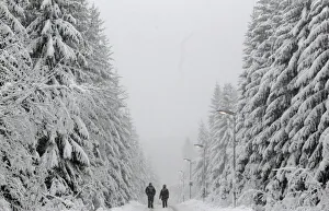 People walk under heavy snowfall near the eastern German town of Altenberg People walk under heavy snowfall near the eastern German town of Altenberg