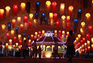 People walk past lanterns on Vesak day in Colombo People walk past lanterns on Vesak day in Colombo