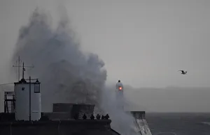 People watch as large waves and high winds associated with Storm Ffion hit the seawall People watch as large waves and high winds associated with Storm Ffion hit the seawall