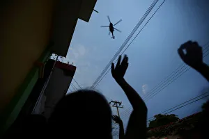 People wave at a helicopter after an earthquake that struck off the southern coast of People wave at a helicopter after an earthquake that struck off the southern coast of