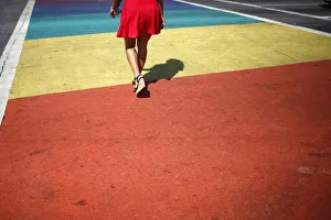 A person walks across a rainbow pedestrian crossing on a road in West Hollywood A person walks across a rainbow pedestrian crossing on a road in West Hollywood