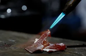 A piece of silver is melted to make a ring in Soledad Borels workshop in San Jose A piece of silver is melted to make a ring in Soledad Borels workshop in San Jose