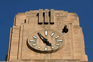 A pigeon flies past a stopped clock on the Lakshmi Building in Karachi A pigeon flies past a stopped clock on the Lakshmi Building in Karachi