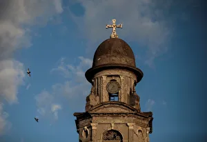 Pigeons fly past a stopped clock tower marking the time of the 1972 earthquake in the old Pigeons fly past a stopped clock tower marking the time of the 1972 earthquake in the old
