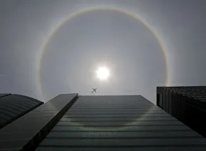 A plane flies past a solar halo in Mexico City A plane flies past a solar halo in Mexico City