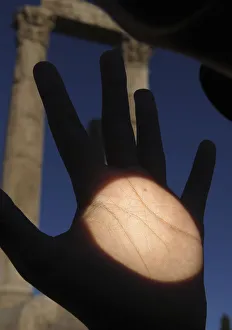 Planet Venus is seen as a black dot on a mans hand as it makes its transit across the Planet Venus is seen as a black dot on a mans hand as it makes its transit across the