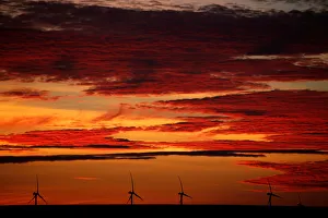 A power-generating windmill turbine is pictured during sunrise at a wind park in A power-generating windmill turbine is pictured during sunrise at a wind park in