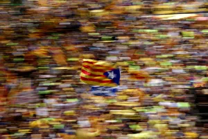 A pro-independence supporter waves a Catalan separatist flag, known as Estelada A pro-independence supporter waves a Catalan separatist flag, known as Estelada