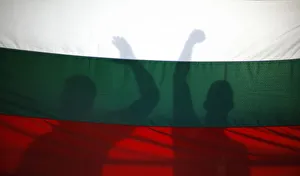 Protesters cast their shadows on a Bulgarian flag as they shout anti-government slogans Protesters cast their shadows on a Bulgarian flag as they shout anti-government slogans