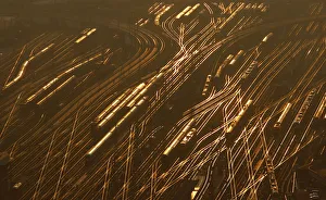 Railway tracks lead towards the main train station as the sun sets on a freezing cold Railway tracks lead towards the main train station as the sun sets on a freezing cold