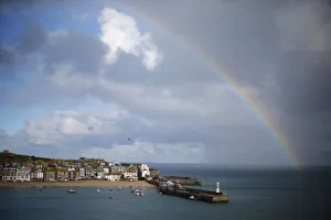 A rainbow forms as a squall moves past the harbour in St Ives in Cornwall A rainbow forms as a squall moves past the harbour in St Ives in Cornwall