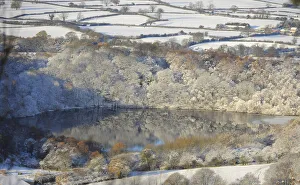 Reflections of snow covered trees are seen in a lake near Sutton Bank Reflections of snow covered trees are seen in a lake near Sutton Bank