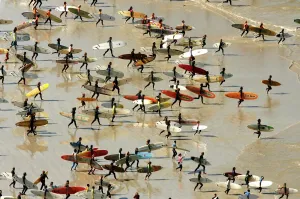 Cape Town Prints: Print of 71 surfers on a single wave at Muizenberg, South Africa