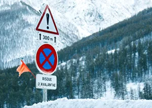 Road signs are pictured on a snow-covered road in Saint-Pancrace as winter weather Road signs are pictured on a snow-covered road in Saint-Pancrace as winter weather