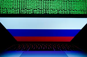 Russian flag is seen on the laptop screen in front of a computer screen on which cyber Russian flag is seen on the laptop screen in front of a computer screen on which cyber