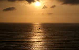 A sailboat sails during sunset in the Pacific Ocean in Lima A sailboat sails during sunset in the Pacific Ocean in Lima