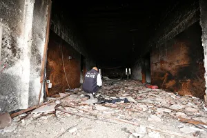 Security personnel inspects the site of a suicide attack on the electoral commission in Security personnel inspects the site of a suicide attack on the electoral commission in