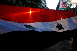 The shadow of a protester holding a Palestinian flag is seen during a protest against the The shadow of a protester holding a Palestinian flag is seen during a protest against the