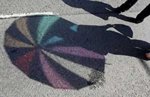 The shadow of an umbrella is cast on the ground during the annual gay pride parade The shadow of an umbrella is cast on the ground during the annual gay pride parade