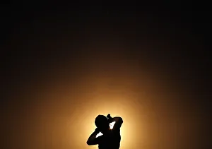 A silhouette of a man fixing his headband before going for a run is seen at Galle-Face A silhouette of a man fixing his headband before going for a run is seen at Galle-Face