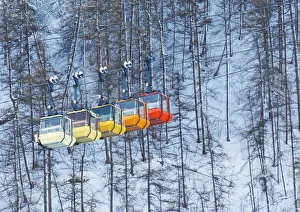 Ski lift chairs are pictured on snow-covered mountain in Saint-Pancrace as winter weather Ski lift chairs are pictured on snow-covered mountain in Saint-Pancrace as winter weather