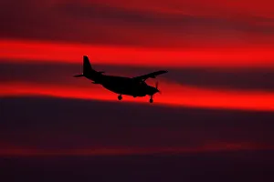 A small propeller plane lands after sun set in San Diego, California A small propeller plane lands after sun set in San Diego, California