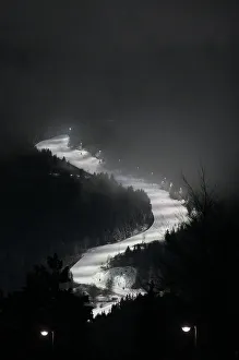 Smog is seen on an illuminated ski slope of the northern mountain resort of Alpes de Smog is seen on an illuminated ski slope of the northern mountain resort of Alpes de