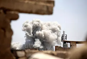 Smoke billows at the position of the Islamic State militants after it was hit by a rocket Smoke billows at the position of the Islamic State militants after it was hit by a rocket
