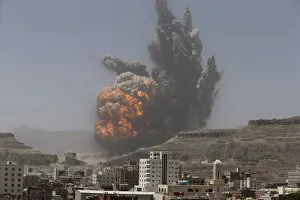 Smoke rises during an air strike on an army weapons depot on a mountain overlooking Smoke rises during an air strike on an army weapons depot on a mountain overlooking