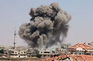 Smoke rises after airstrikes on a rebel-held part of the southern city of Deraa Smoke rises after airstrikes on a rebel-held part of the southern city of Deraa