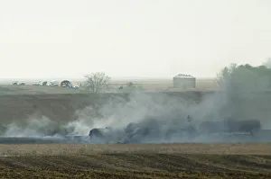 Smoke from the wreckage of several oil tanker cars that derailed in a field near Heimdal Smoke from the wreckage of several oil tanker cars that derailed in a field near Heimdal