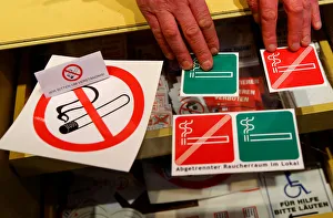 No smoking signs are seen on a table in a sign shop in Vienna No smoking signs are seen on a table in a sign shop in Vienna