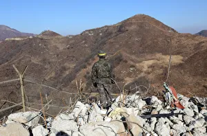 A South Korean army soldier stands guard at the Souths dismantled guard post inside the A South Korean army soldier stands guard at the Souths dismantled guard post inside the