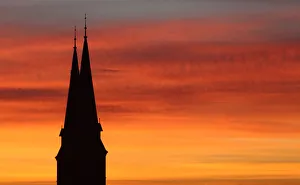 Spires of Familienkirche are silhouetted against sky during sunrise in Vienna Spires of Familienkirche are silhouetted against sky during sunrise in Vienna