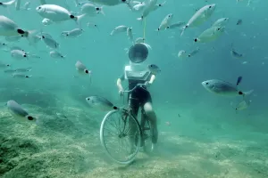 Prints of A woman dives and pretends to ride a bike in Underwater Park in Pula, Croatia, August 1, 2017. REUTERS/Antonio Bronic - RC14C0F1F570 Croatia Prints: A woman dives and pretends to ride a bike in an underwater setting, Print
