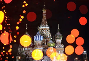 Images Dated 14th December 2005: St Basils Cathedral in Moscows Red Square is seen through illuminated New Year