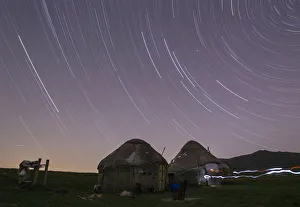Star trails form over yurts in a long exposure picture on the mountainous Assy plateau Star trails form over yurts in a long exposure picture on the mountainous Assy plateau