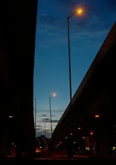 Street lights are seen between viaducts during dusk in Bogota city Street lights are seen between viaducts during dusk in Bogota city