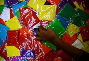A street vendor takes a packets of vermilion powder kept on sale ahead of Tihar festival A street vendor takes a packets of vermilion powder kept on sale ahead of Tihar festival