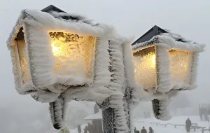 Streetlamps are covered in snow and ice outside a restaurant on the peak of the Feldberg Streetlamps are covered in snow and ice outside a restaurant on the peak of the Feldberg