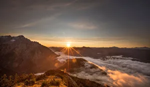 The sun rises over mountain summits in the Austrian village of Absam The sun rises over mountain summits in the Austrian village of Absam