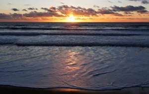 The sun sets over a beachfront along the Atlantic Ocean coast in Montalivet-les-Bains The sun sets over a beachfront along the Atlantic Ocean coast in Montalivet-les-Bains