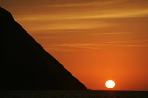 Sun sets near San Lorenzo Island as seen from Limas Port Callao Sun sets near San Lorenzo Island as seen from Limas Port Callao