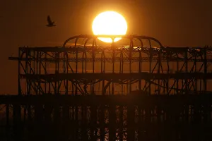 The sun sets behind the old West Pier in Brighton, southern England The sun sets behind the old West Pier in Brighton, southern England